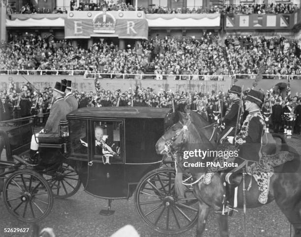 Sir Winston and Lady Clementine Churchill travel in procession past Hyde park Corner, London, on their way to Westminster Abbey to attend the...