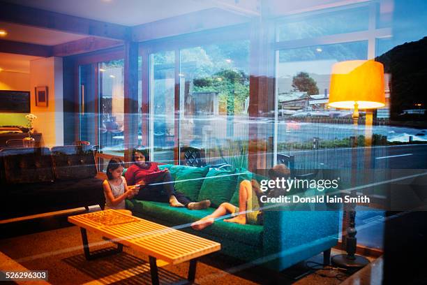 Mother and children relaxing together in modern living room