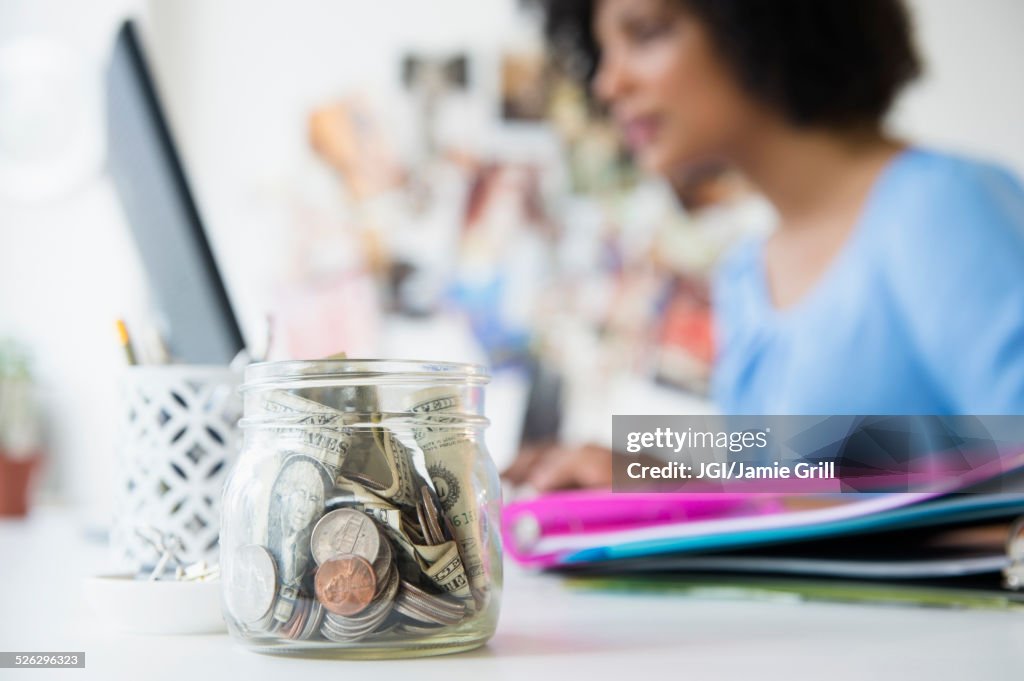Close up of change jar on desk