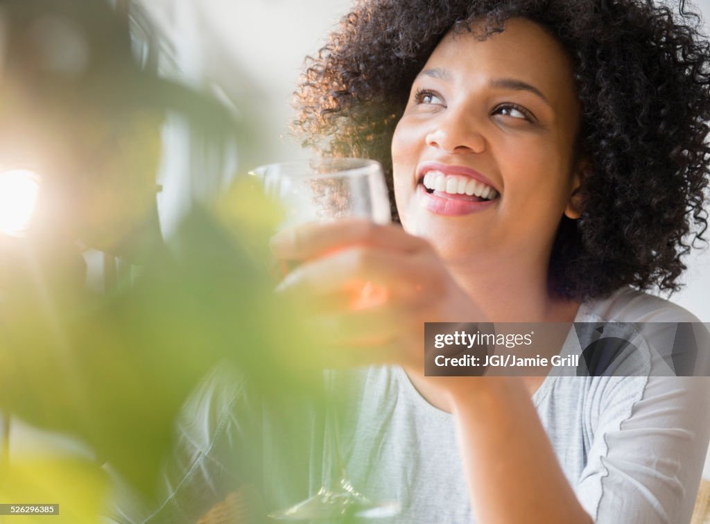 Smiling woman drinking glass of wine