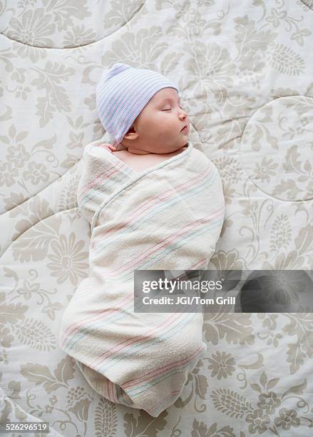 swaddled asian baby sleeping on bed - baby blanket stock pictures, royalty-free photos & images