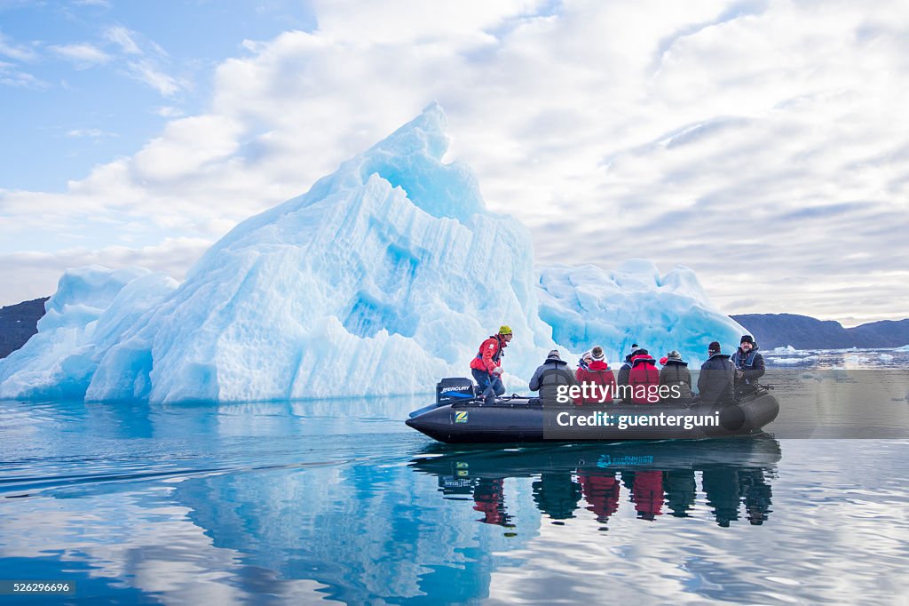 Touristen in einem Zodiac in vor einem mit Eisbergen, Grönland