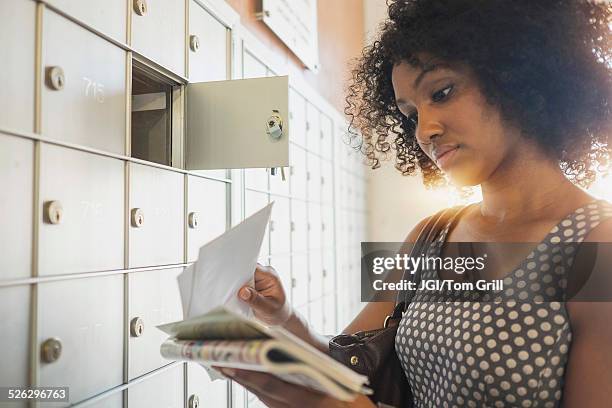 mixed race businesswoman checking mailbox - reading mail stock pictures, royalty-free photos & images