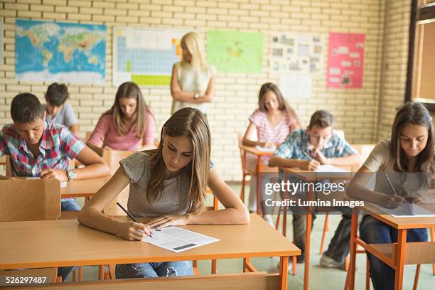 students taking test in classroom - educazione secondaria di scuola media foto e immagini stock