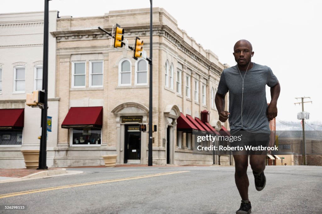 Black man running on city street