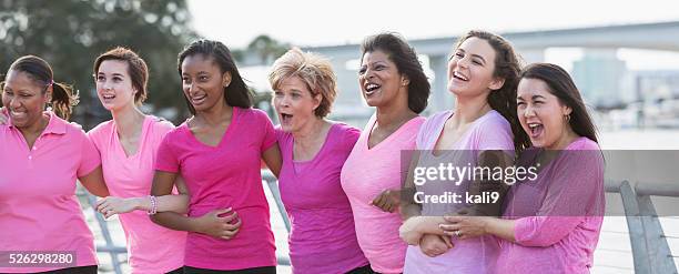 mothers and daughters for breast cancer awareness - community arm in arm stock pictures, royalty-free photos & images