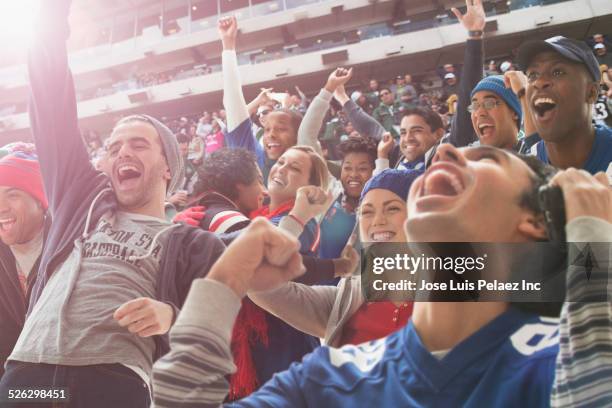 fans cheering at american football game - supporters photos et images de collection