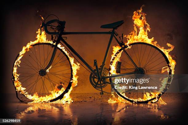 silhouette of bicycle with flaming tires - burning rubber stock pictures, royalty-free photos & images