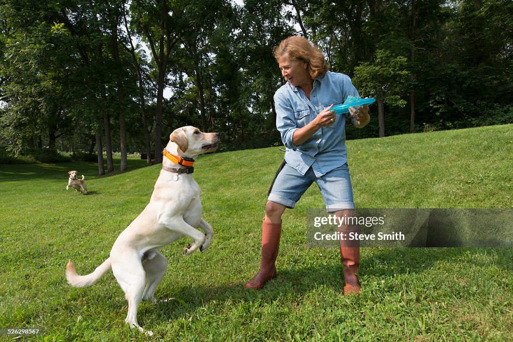 Caucasian woman playing with dog in park