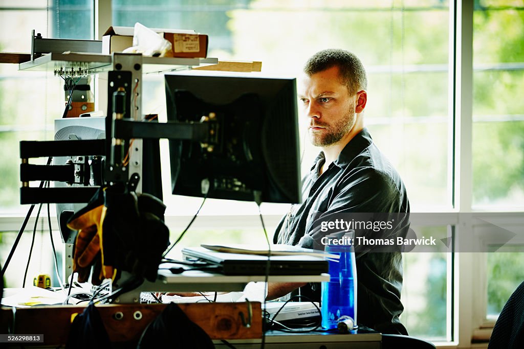 Engineer standing at desk designing project