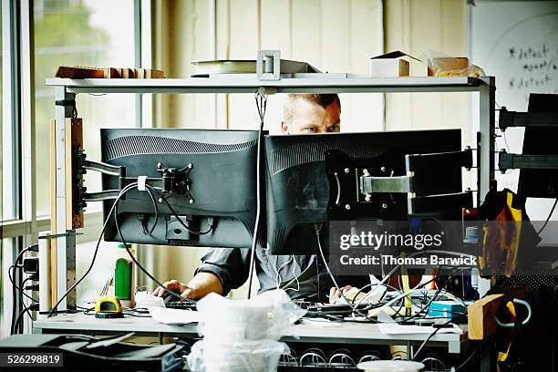 engineer doing computer aided design in workshop - computer aided design stockfoto's en -beelden