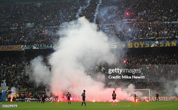 Flares rain down onto the pitch from Inter Milan fans during the UEFA Champions League quarter-final second leg betweenInter Milan and AC Milan at...