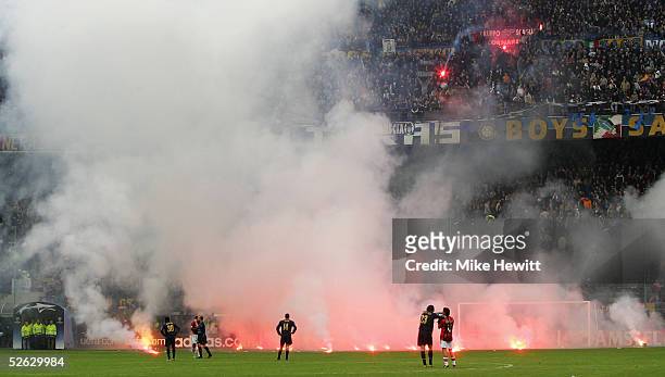 Flares rain down onto the pitch from Inter Milan fans during the UEFA Champions League quarter-final second leg betweenInter Milan and AC Milan at...
