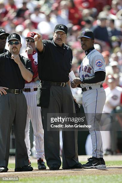 Umpire crew chief Tim McClelland points as he meets with Willie Randolph of the New York Mets and Dave Wiley of the Cincinnati Reds prior to the...