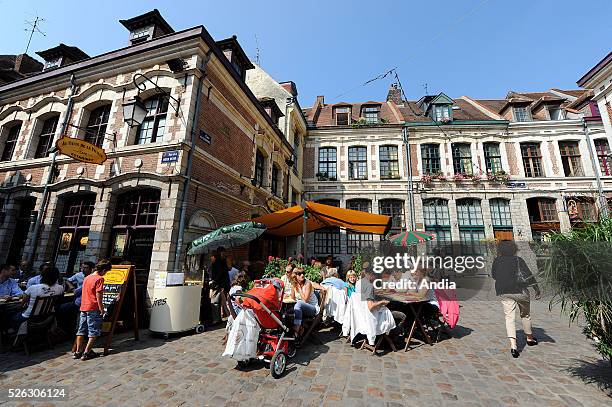 Real estate in Lille in the Old Town. Facades of old houses, "Place aux Oignons" square and terrace of the tavern-cafe "Au vieux de la vieille"....