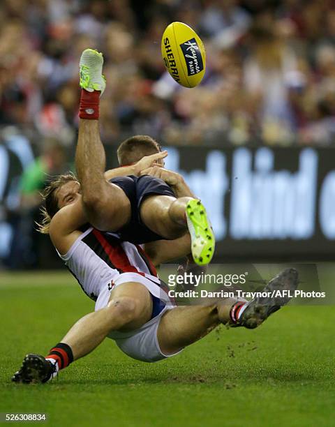 Josh Bruce of the Saints tackles Ben Kennedy of the Demons during the round six AFL match between the Melbourne Demons and the St Kilda Saints at...