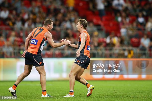 Lachie Whitfield of the Giants celebrates with Steve Johnson of the Giants after kicking a goal during the round six AFL match between the Greater...