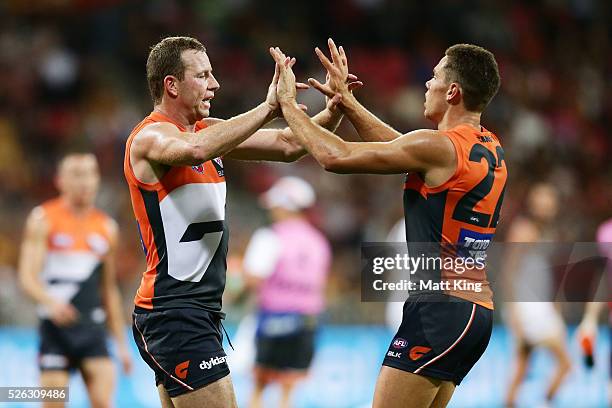 Steve Johnson of the Giants celebrates with Josh Kelly of the Giants after kicking a goal during the round six AFL match between the Greater Western...