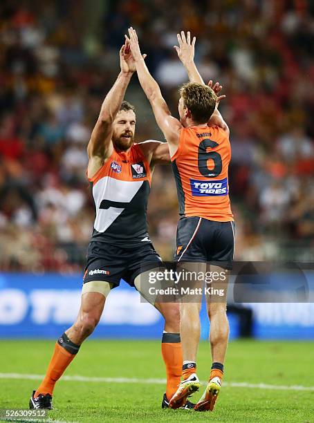 Lachie Whitfield of the Giants celebrates with Shane Mumford of the Giants after kicking a goal during the round six AFL match between the Greater...