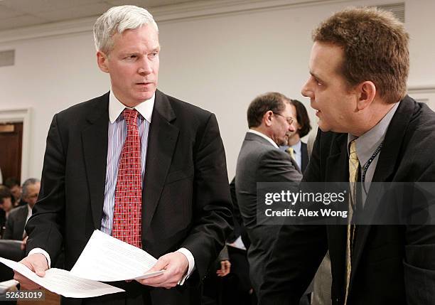 Internal Revenue Service Commissioner Mark Everson listens to his aide Leonard Oursler prior to a hearing before a House Ways and Means Subcommittee...