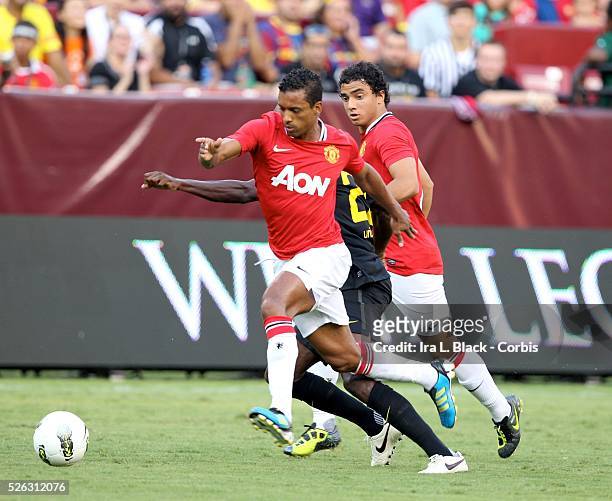 Manchester United player Nani drives the ball toward the goal and scores during the World Football Challenge Friendly match between FC Barcelona and...