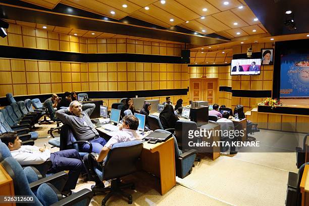 Iranian journalists work in a press room at the interior ministry in the capital Tehran on April 30, 2016 as they follow the preliminary results of...