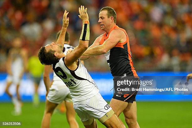 Steve Johnson of the Giants and Luke Hodge of the Hawks wrestle during the round six AFL match between the Greater Western Sydney Giants and the...