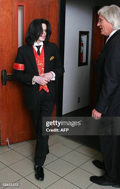 Michael Jackson and attorney Thomas Mesereau Jr. Speak as they exit the courtroom after testimony in Jackson's molestation trial at the Santa Barbara...