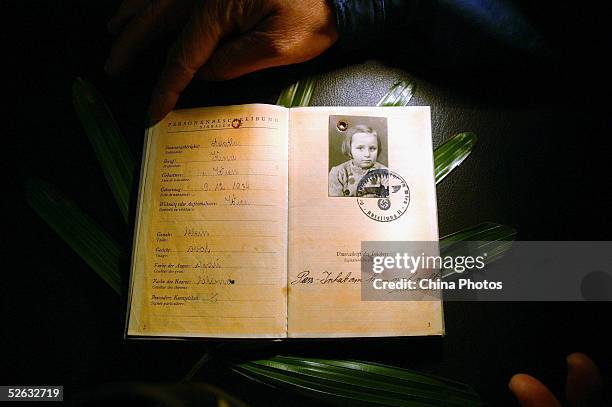 Australian woman Gerti Brender displays her passport used 66 years ago during a passport returning ceremony at Ohel Moishe Synagogue on April 14,...