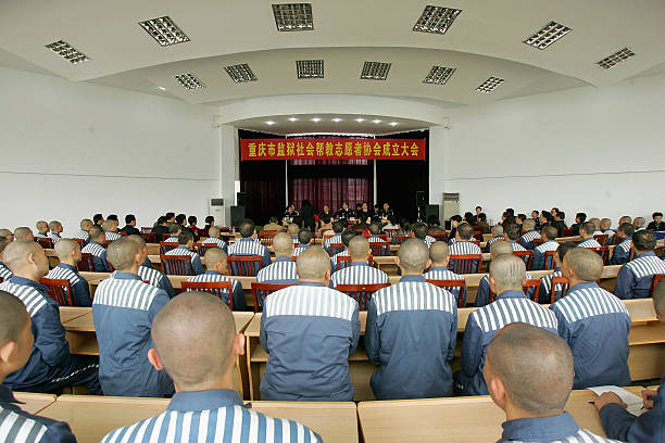 Inmates attend the founding ceremony of "Volunteers Helping Inmates In Chongqing Prison Association" on April 14, 2005 in Chongqing, China. To better...