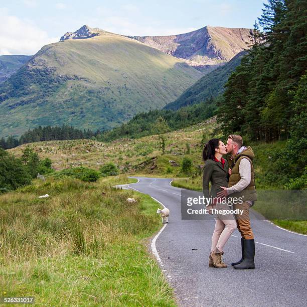 uk, scotland, highlands region, couple kissing - scotland people stock pictures, royalty-free photos & images
