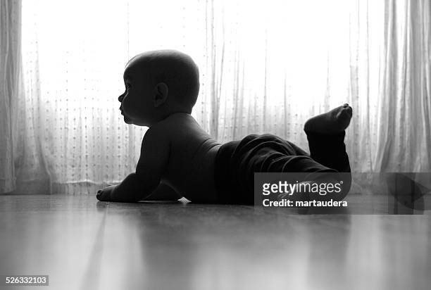 portrait of baby lying on floor - 這う ストックフォトと画像