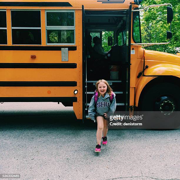 smiling girl getting off school bus, wisconsin, america, usa - disembarking stock pictures, royalty-free photos & images