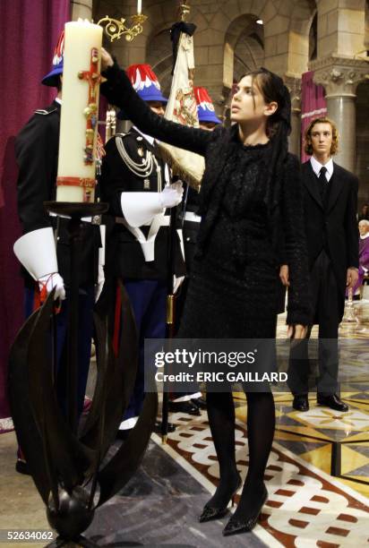 Princess Caroline of Hanover's daughter Princess Charlotte Casiraghi lights a candle as his brother Prince Pierre looks on during the funeral mass of...