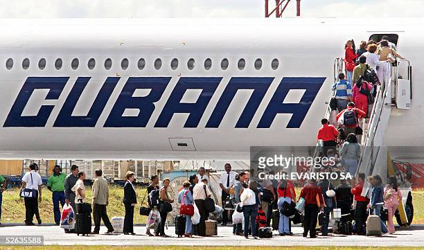Group of 69 Cuban doctors embark on a Cubana de Aviacion aircraft to return to Cuba at Brasilia's International Airport 15 April, 2005. The Brazilian...