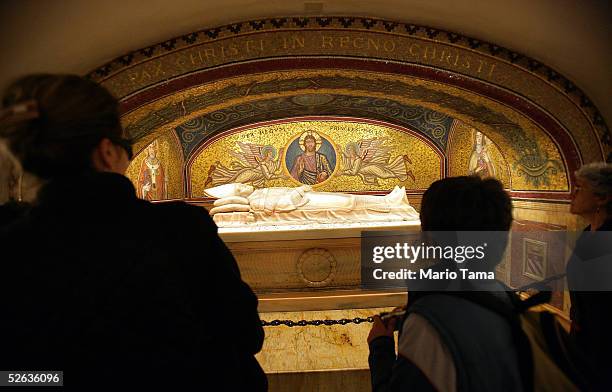 Visitors view a crypt in the grotto beneath Saint Peter's Basilica where Pope John Paul II has been buried April 15, 2005 in Vatican City. A total of...