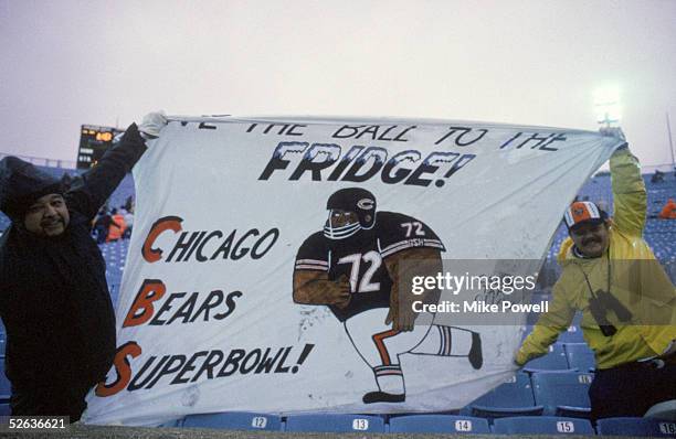 Fans of defensive lineman William Perry of the Chicago Bears display a banner which reads "Give the Ball to the Fridge" during a game between the...