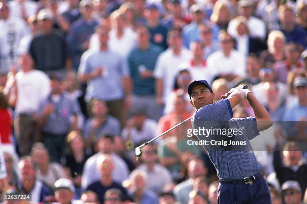 Tiger Woods watches the flight of the ball as he follows through on his swing on the sixteenth hole during the Phoenix Open at the Tournament Players...