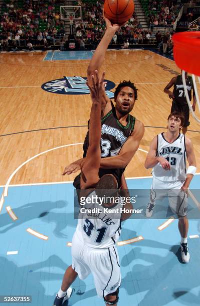 Michael Olowokandi of the Minnesota Timberwolves shoots against Jarron Collins of the Utah Jazz on April 15, 2005 at the Delta Center in Salt Lake...