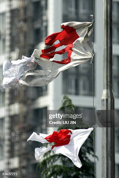 Damaged Japanese flags float during an anti-Japanese rally in Shanghai, 16 April 2005. Thousands of people staged violent anti-Japanese rallies...