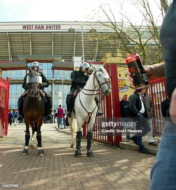 Police stand guard outside the ground prior to the Coca Cola Championship match between West Ham and Millwall at Upton Park on April 16, 2005 in...