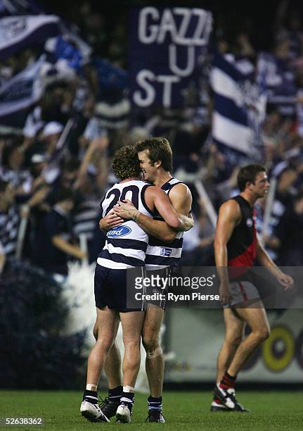 Henry Playfair and Steven Johnson for the Cats celebrate a goal during the round four AFL match between the Geelong Cats and the Essendon Bombers at...