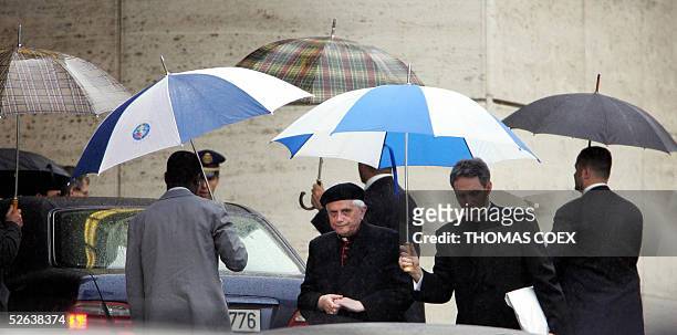 German Cardinal Joseph Ratzinger leaves with unidentified assistants the Paul VI hall at the end of the General Congregation assembly of the...