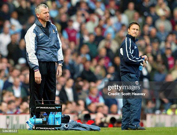 Dejected West Ham manager , Alan Pardew is watched by Denis Wise during the Coca Cola Championship match between West Ham and Millwall at Upton Park...