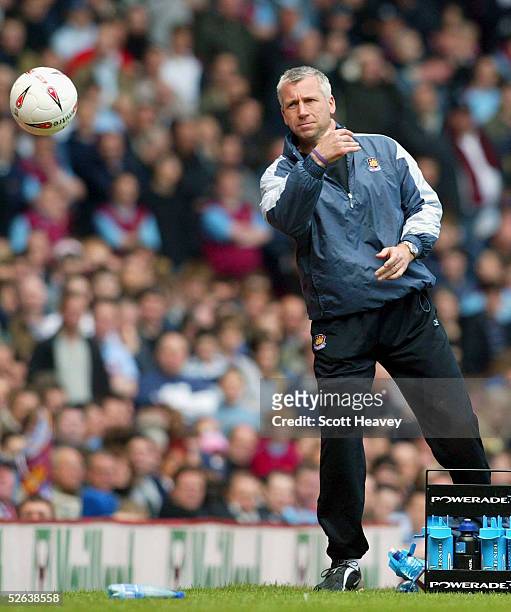 West Ham manager Alan Pardew returns the ball during during the Coca Cola Championship match between West Ham and Millwall at Upton Park on April 16,...