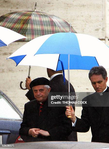German Cardinal Joseph Ratzinger leaves with an unidentified assistant the Paul VI hall at the end of the General Congregation assembly of the...