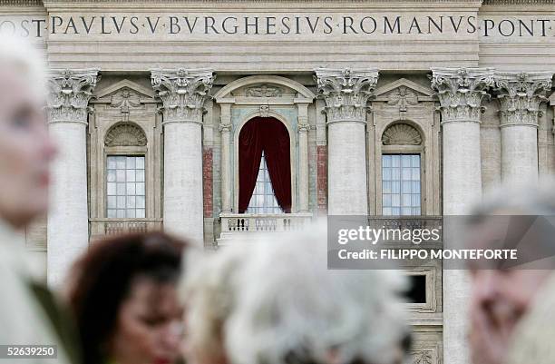 Velvet drapes hang above the central balcony's of St. Peter's Basilica facade at the Vatican 16 April 2005, where the new Pope will make his first...