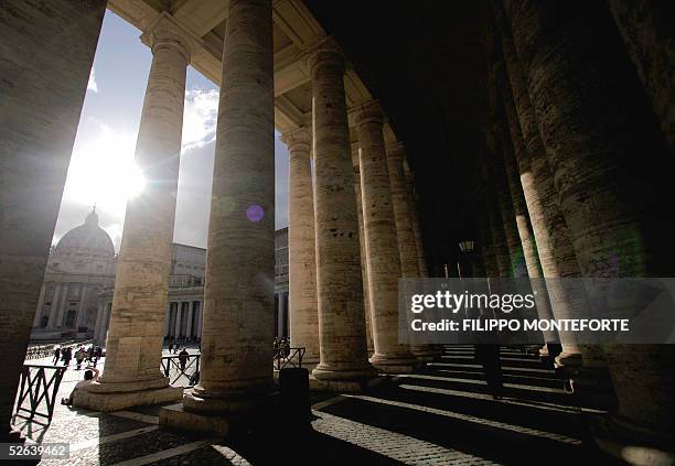 Priest walks under St.Peter's Basilica colonade at the Vatican April 16 2005, where the new Pope will make his first appearance after the conclave...