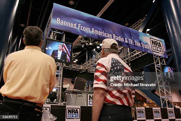 Gun enthusiasts check out live feeds of National Rifle Association Institute of Legislative Action's Executive Director Chris Cox speaking at the...