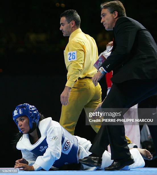 Puerto Rico's Iniabelle Diaz lies on the floor KO after receiving a high kick by Korean Sin Kyung Hyeon during their women's over 72 kg final match...